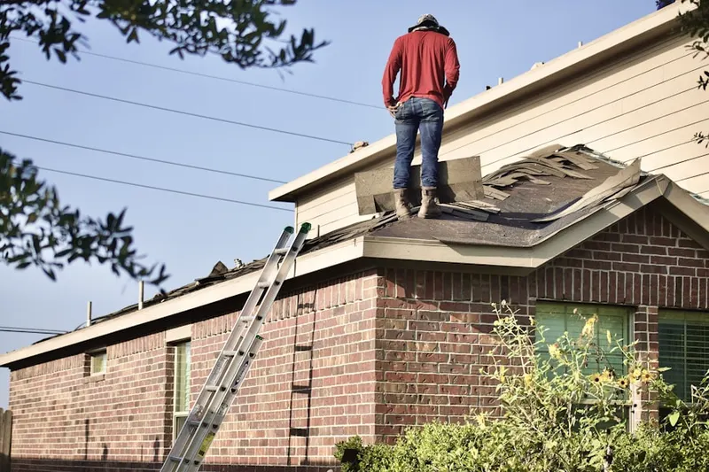 Professional roofer working on a residential roof in Greenspring